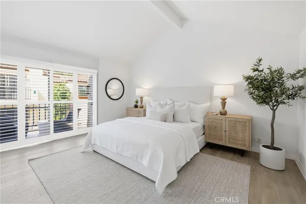 a bedroom with bed and a potted plant