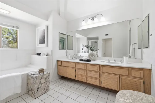 a bathroom with a granite countertop sink mirror and bathtub