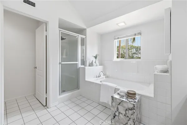 a bathroom with a sink a bathtub and a shower