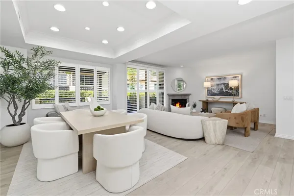 a living room with fireplace furniture and a large window