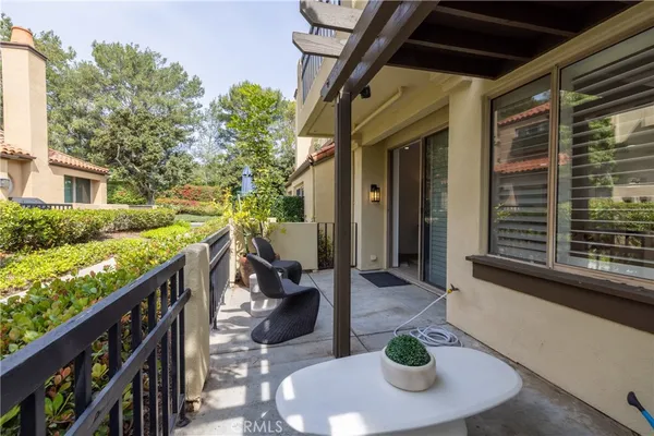 a balcony with table and chairs