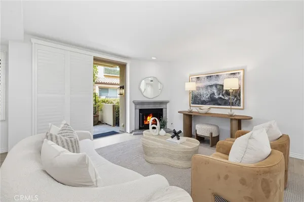 a living room with furniture a fireplace and a large mirror