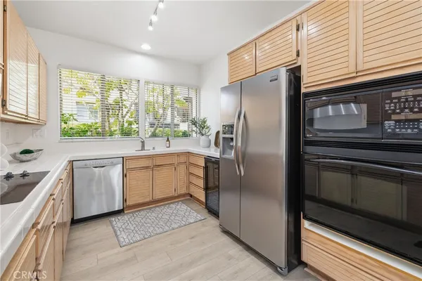 a kitchen with a refrigerator sink and stove