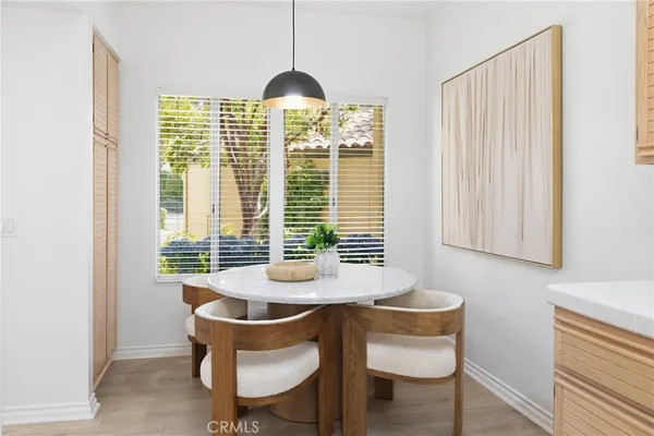 a kitchen with a table chairs and a refrigerator