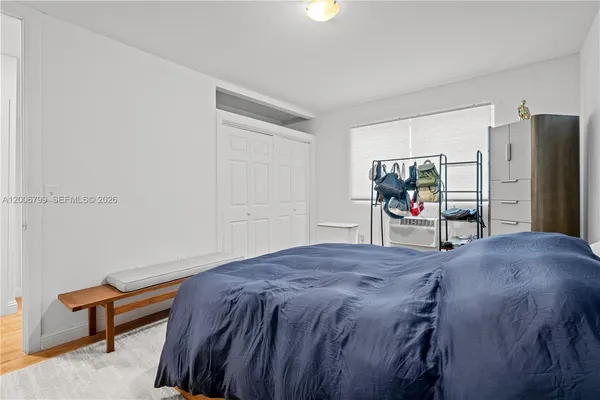 a bed sitting in a bedroom and tv