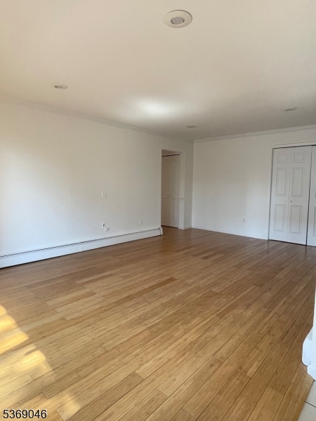 21 River Road, Unit G Nutley, NJ 07110 - Photo 8 of 22 an empty room with wooden floor