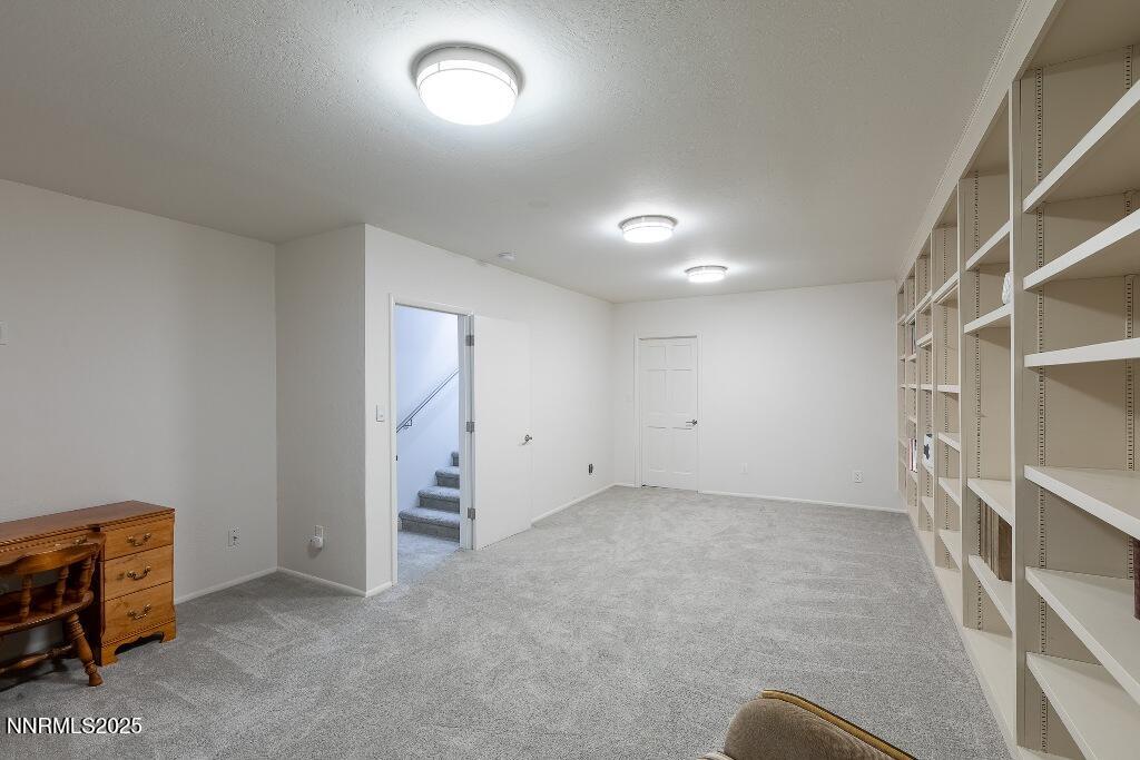 4811 Lakeridge Terrace West Reno, NV 89509 - Photo 35 of 43 an empty room with a fireplace and fan