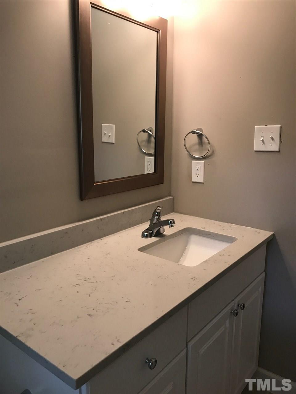 127 Crestview Road Raleigh, NC 27609 - Photo 3 of 9 a bathroom with a sink and a mirror