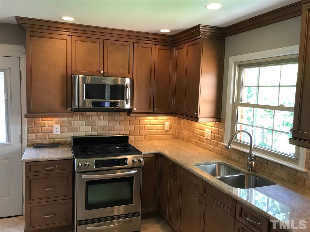 127 Crestview Road Raleigh, NC 27609 - Photo 5 of 9 a kitchen with a sink stove and microwave
