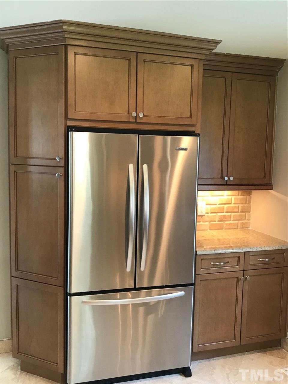 127 Crestview Road Raleigh, NC 27609 - Photo 6 of 9 a metallic refrigerator freezer sitting in a kitchen