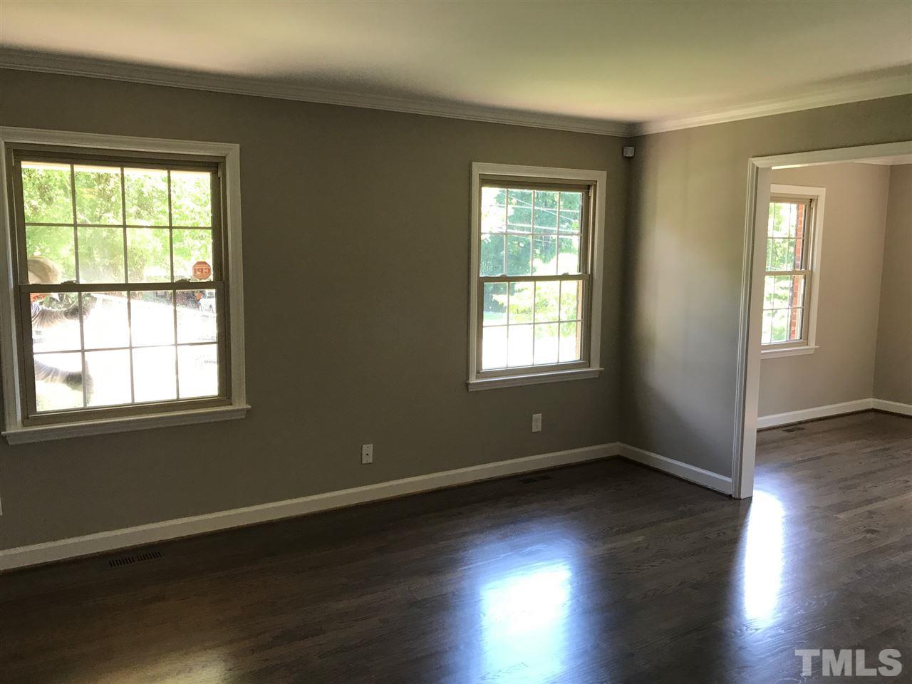 127 Crestview Road Raleigh, NC 27609 - Photo 8 of 9 a view of an empty room with wooden floor and a window