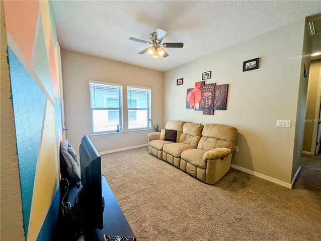 a living room with furniture and a large window