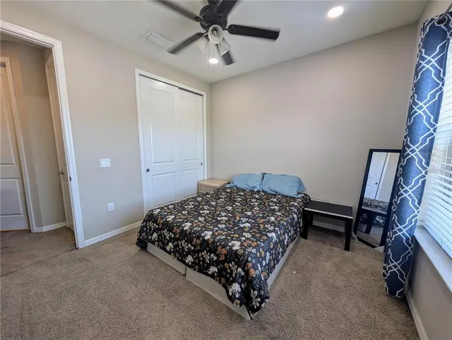 a bedroom with bed and window