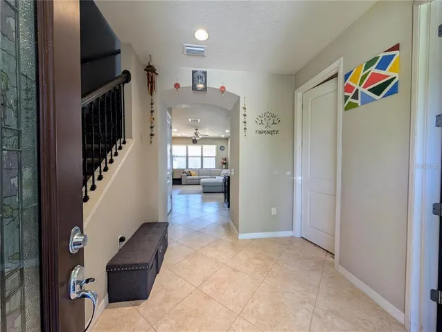 a view of hallway with furniture and wooden floor