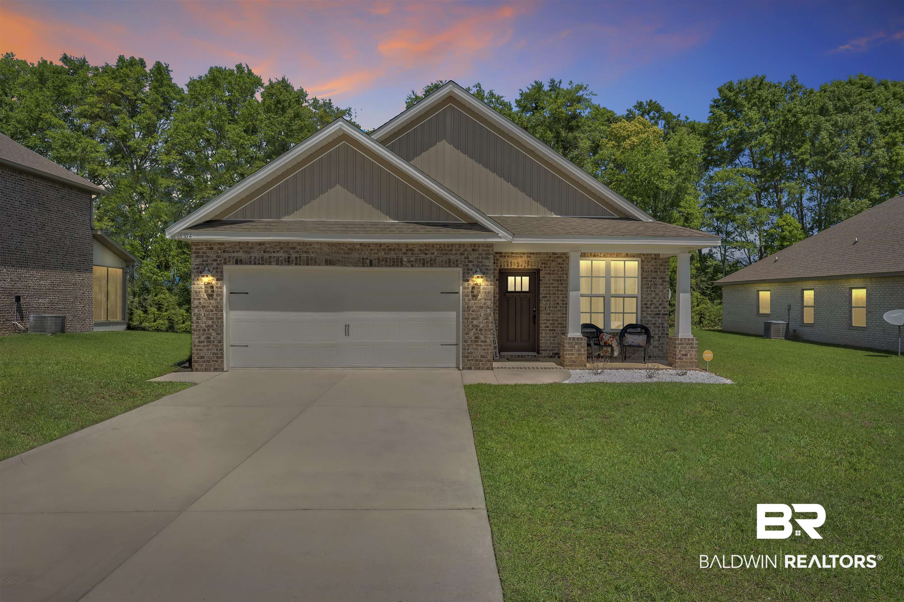 16504 Prado Loop Loxley, AL 36551 - Photo 2 of 45 Craftsman-style home with a front lawn, brick siding, a porch, an attached garage, and driveway
