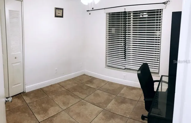 a view of a room with a chair and a potted plant