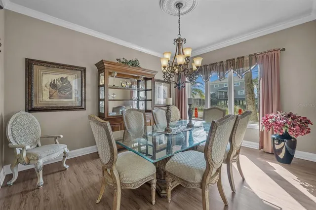 a kitchen with a dining table chairs sink and cabinets