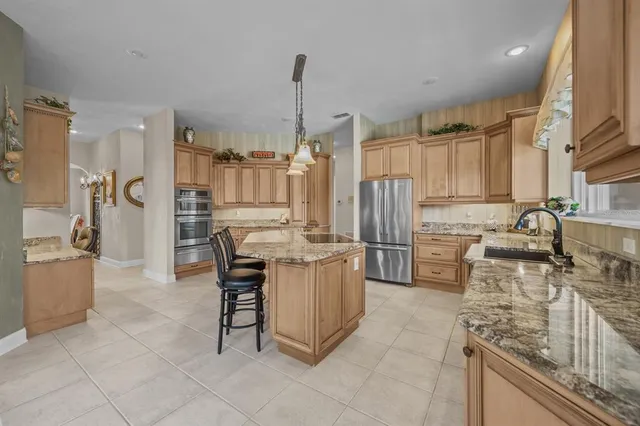 a dining room with furniture a chandelier and window