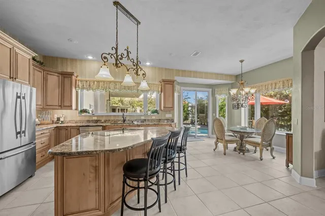 a living room with fireplace furniture and a large window