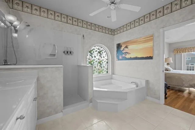 a view of a white house with a yard patio and a fire pit