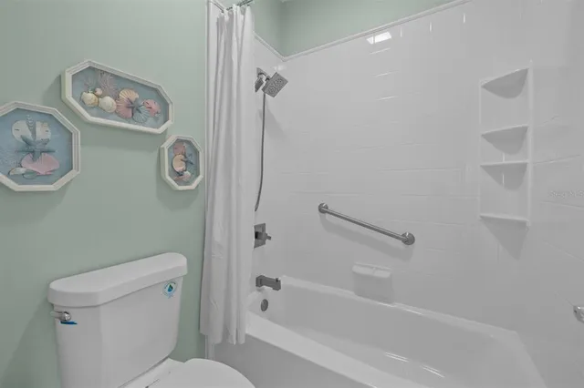 a front view of a house with a garden and a yard