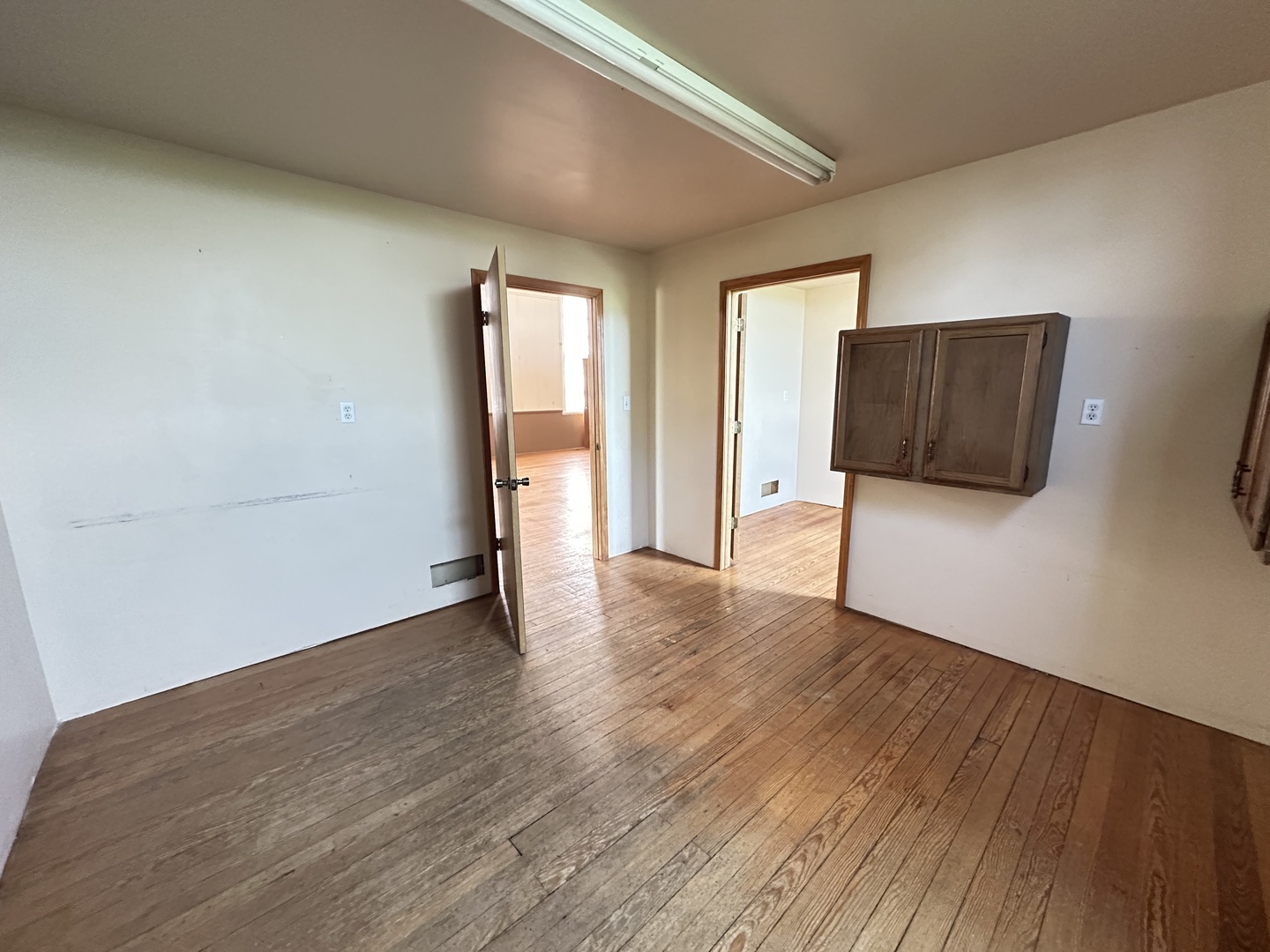 21027 Prairie Chapel Road Farmer City, IL 61842 - Photo 13 of 16 a view of an empty room with wooden floor and a window
