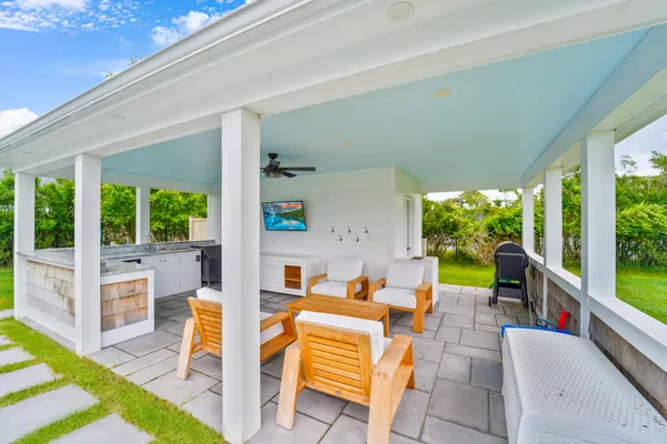 a outdoor space with patio the couches and dining table with a garden view