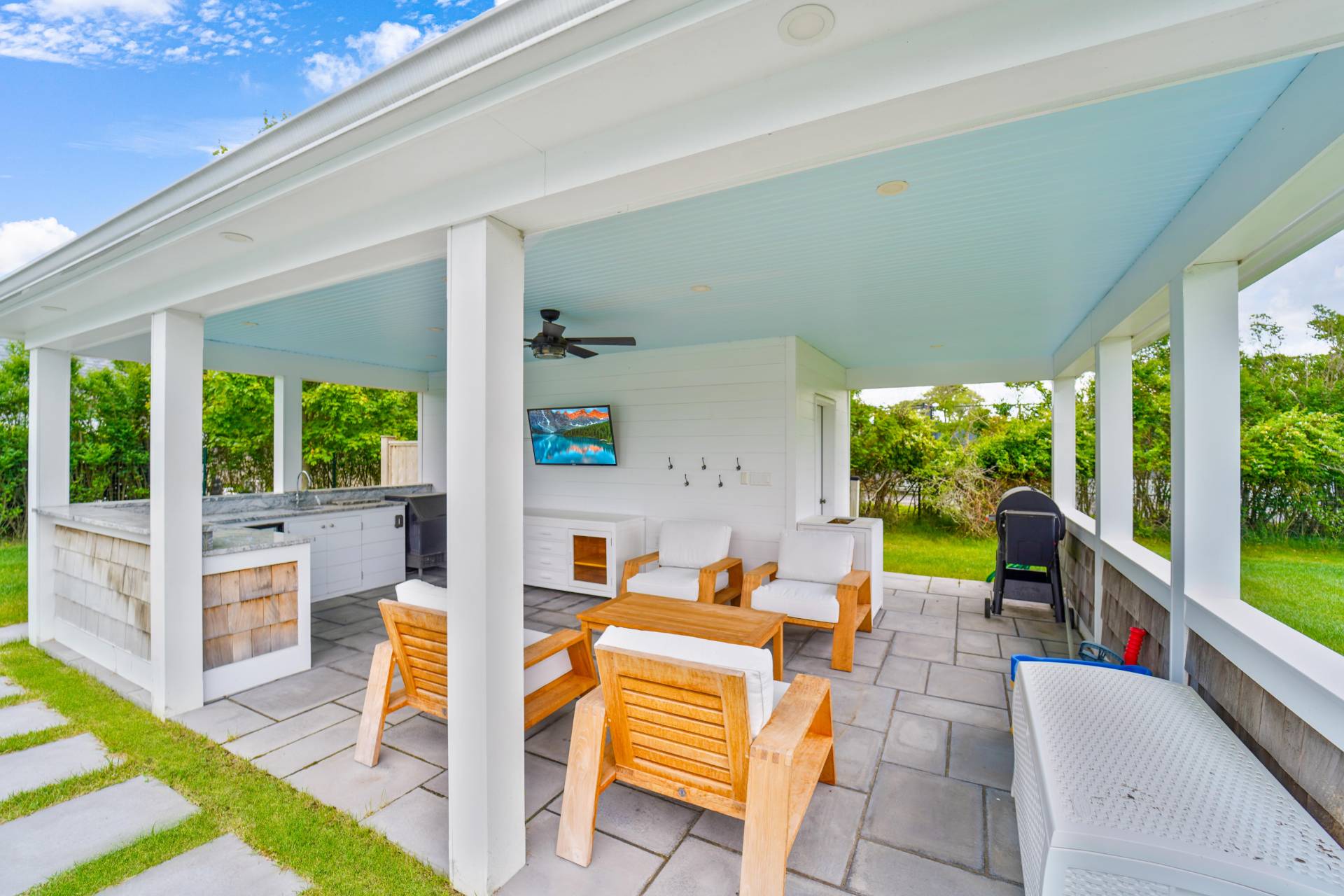 22 Oneck Road Westhampton Beach, NY 11978 - Photo 16 of 29 a outdoor space with patio the couches and dining table with a garden view