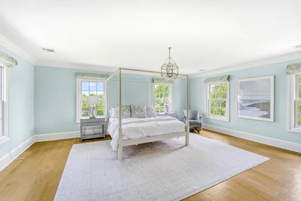 a spacious bedroom with a bed couch and table