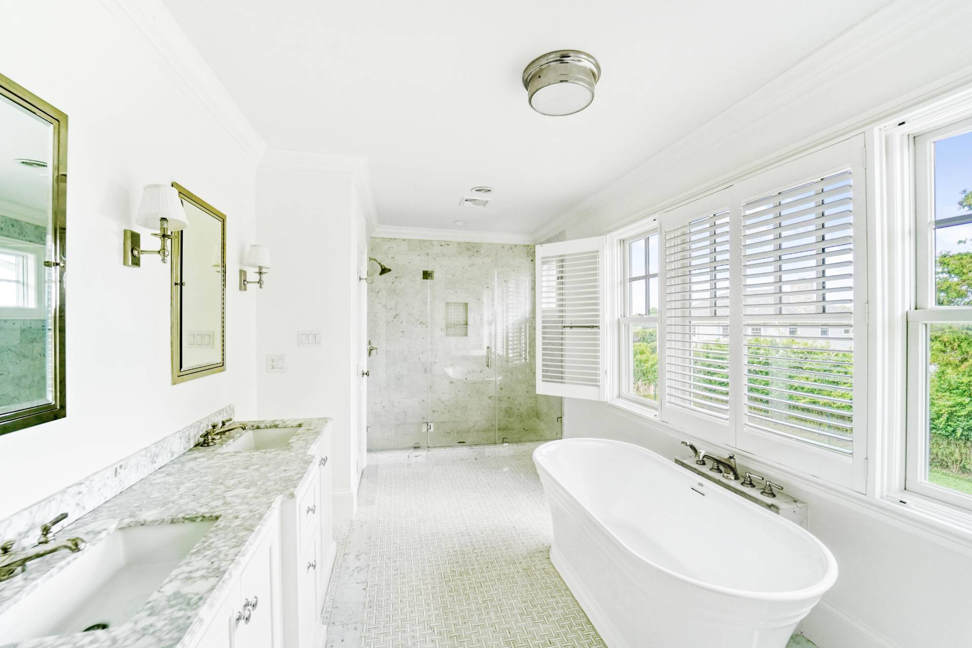 22 Oneck Road Westhampton Beach, NY 11978 - Photo 19 of 29 a spacious bathroom with a granite countertop tub sink and mirror