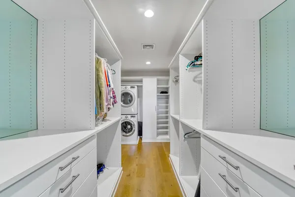 a view of a kitchen with fridge and wooden floor