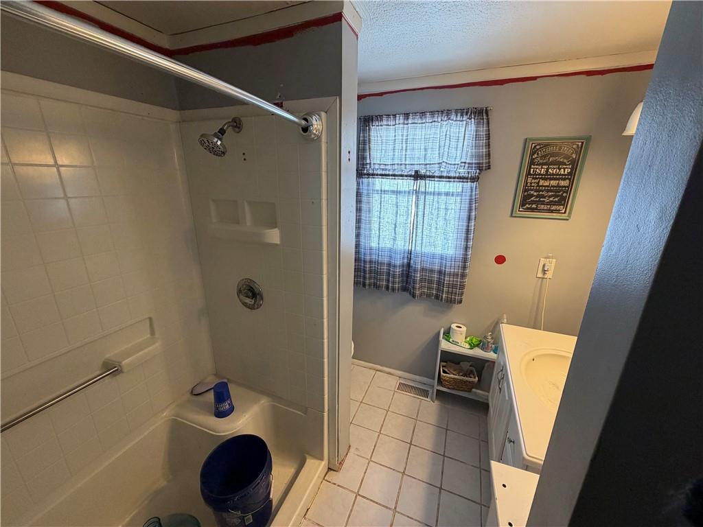 262 Elm Road Uniontown, PA 15401 - Photo 13 of 29 a bathroom with a tub and a shower