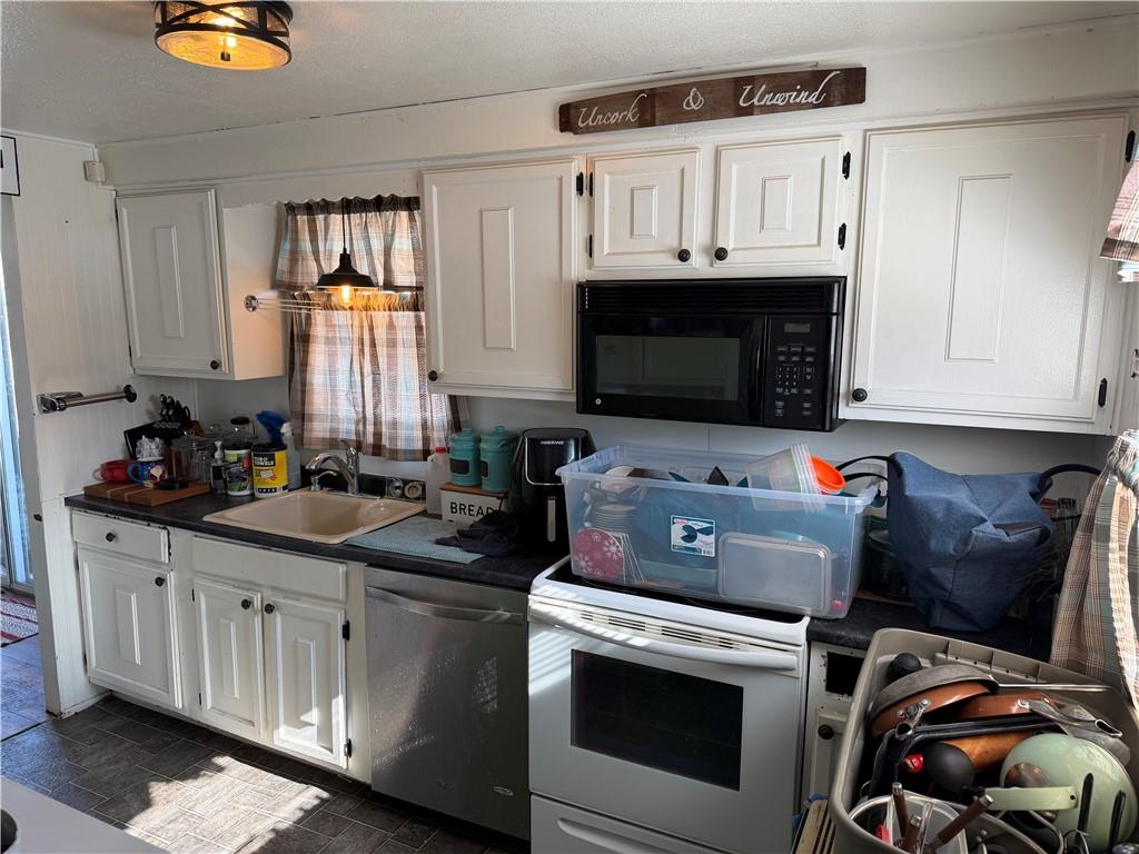 262 Elm Road Uniontown, PA 15401 - Photo 10 of 29 a kitchen with stainless steel appliances a stove a sink and a microwave