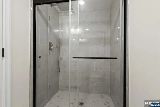 a bathroom with a glass shower door