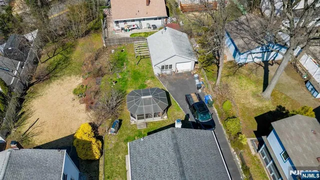 an aerial view of a house with a yard and outdoor seating