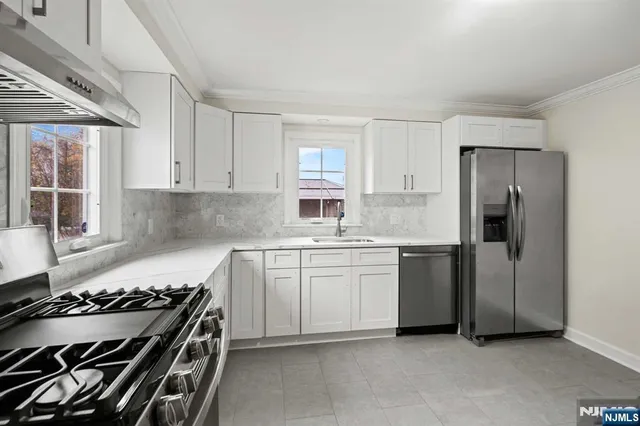 a kitchen with a stove and a refrigerator