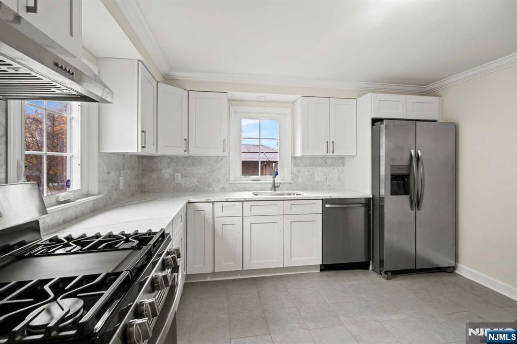238 Springfield Avenue, Unit 1 Rutherford, NJ 07070 - Photo 8 of 33 a kitchen with a stove and a refrigerator