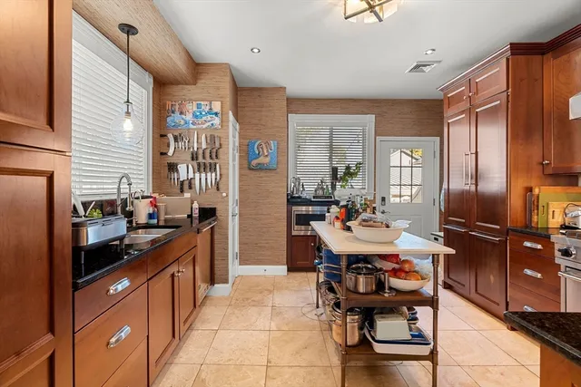 a kitchen with a sink appliances and cabinets