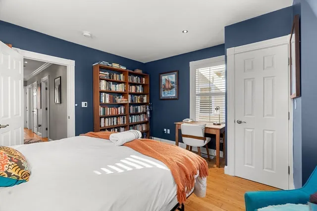a bedroom with a large bed and a window
