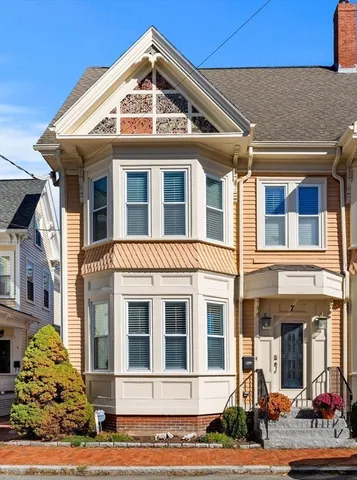 a front view of a residential apartment building with a yard