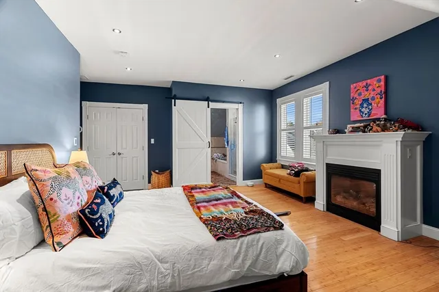 a bedroom with a bed and a fireplace