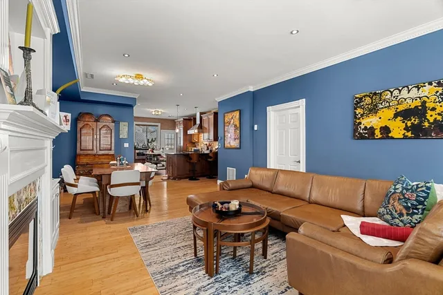 a living room with furniture kitchen view and a fireplace