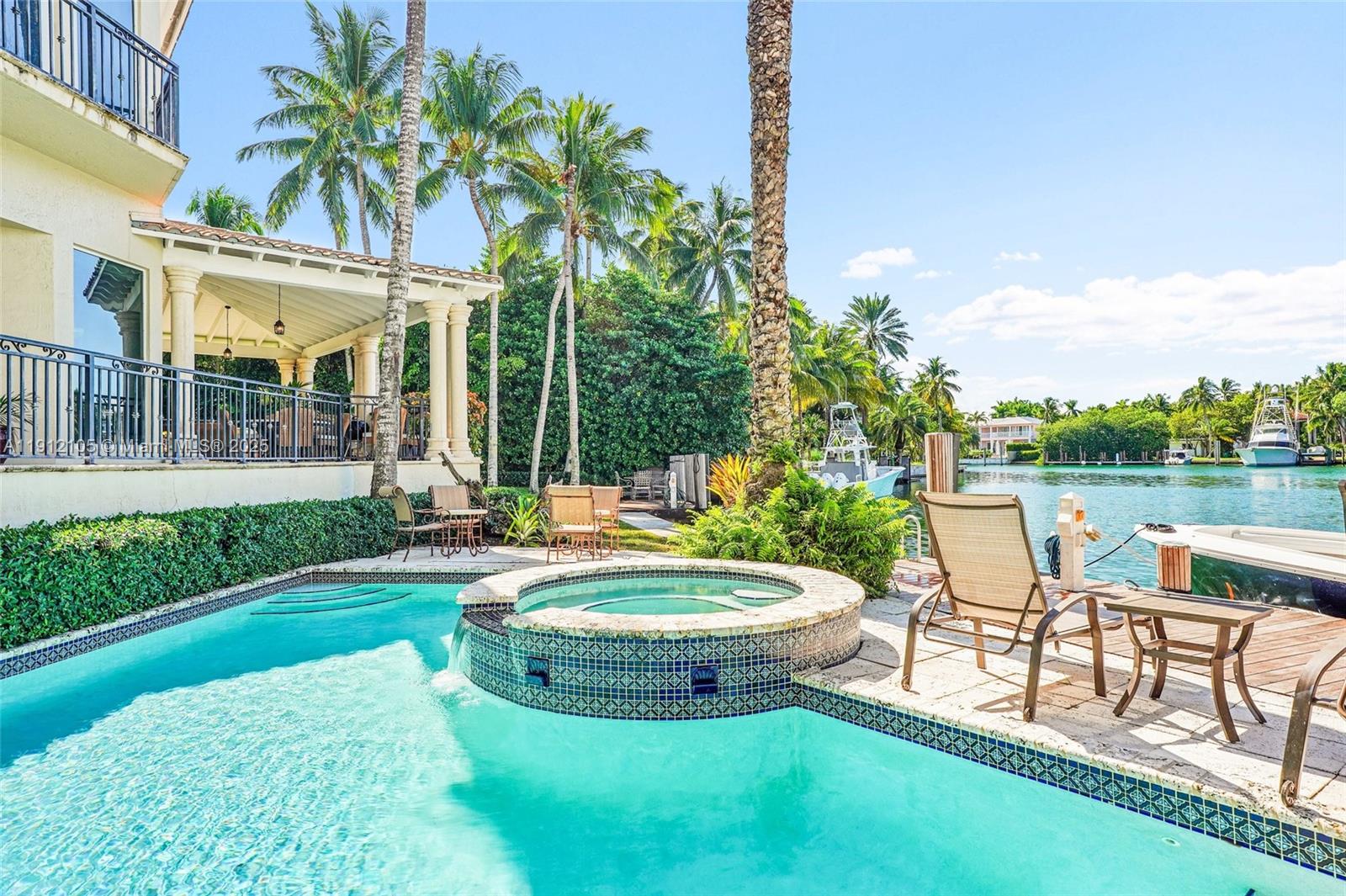 550 Harbor Drive Key Biscayne, FL 33149 - Photo 11 of 65 a view of a patio with table and chairs potted plants and palm tree