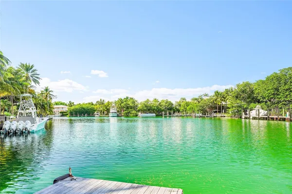 a living room with furniture and floor to ceiling windows