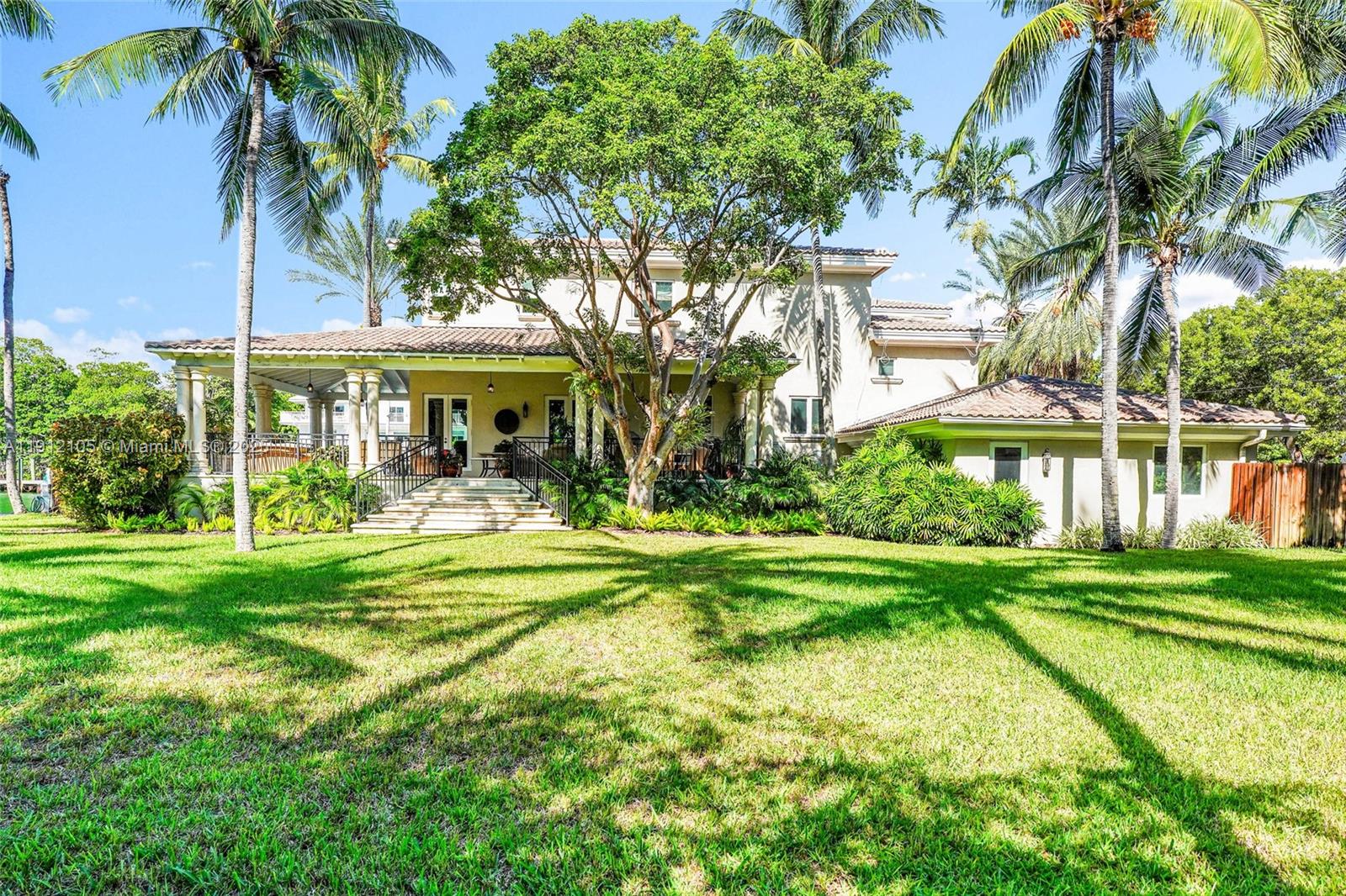 550 Harbor Drive Key Biscayne, FL 33149 - Photo 15 of 65 a front view of a house with a yard table and chairs