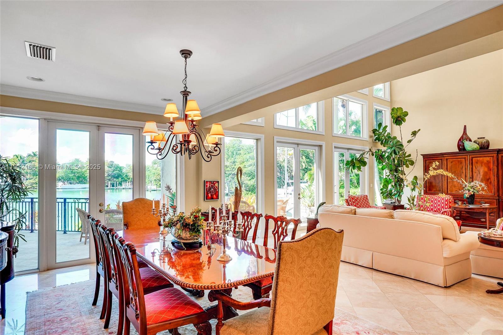 550 Harbor Drive Key Biscayne, FL 33149 - Photo 20 of 65 a dining room with furniture large windows and a chandelier