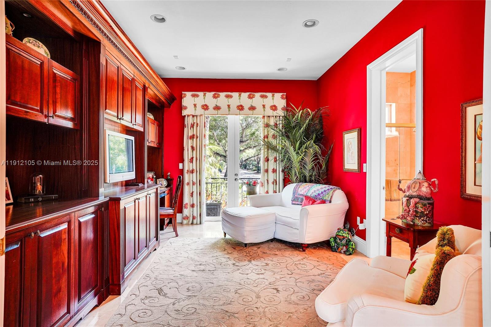550 Harbor Drive Key Biscayne, FL 33149 - Photo 29 of 65 a living room with furniture a flat screen tv and a floor to ceiling window
