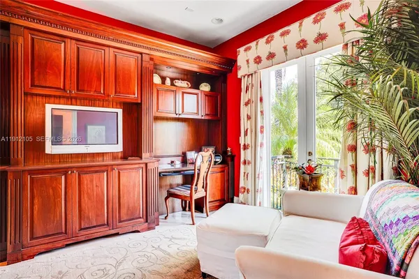 a living room with furniture and a floor to ceiling window