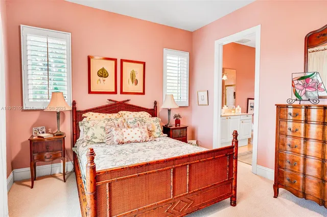 a bedroom with furniture and large windows