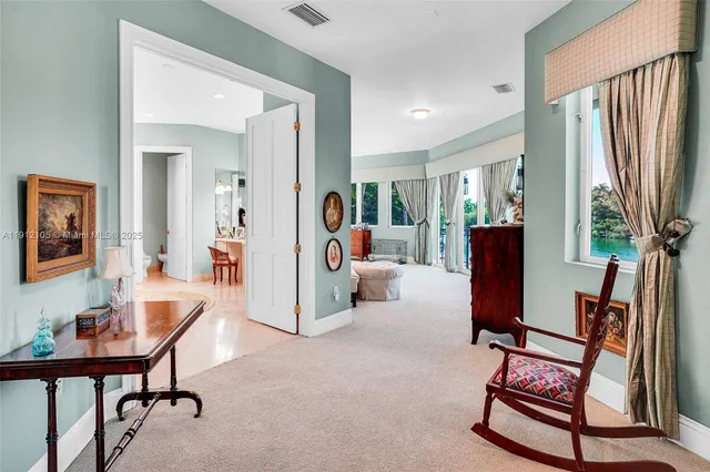 a living room with furniture and large windows